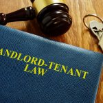 Landlord Tenant Law book with keys and gavel