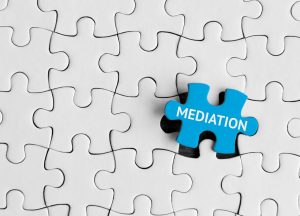 Mediation puzzle concept with blue puzzle piece on a white puzzle board