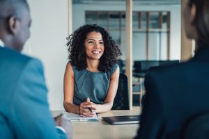 Lawyer meeting with two people about mortgage refinancing