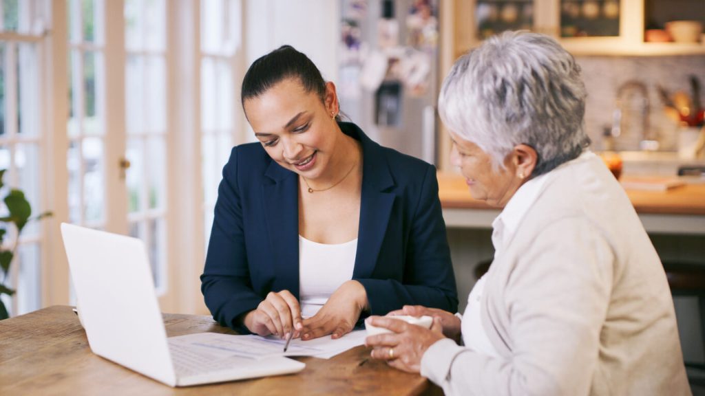 Lawyer explaining paper work to an older woman