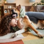 Woman hugging her dog.